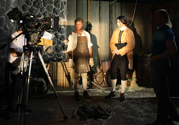 Martin Kove and Macleish Day wait for the next take.  Director Trygve Lode is just outside the lights to the right.